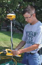 Photo of a Technology Systems Management student working with GPS data acquisition equipment  Photo of a Technology Systems Management student working with GPS data acquisition equipment