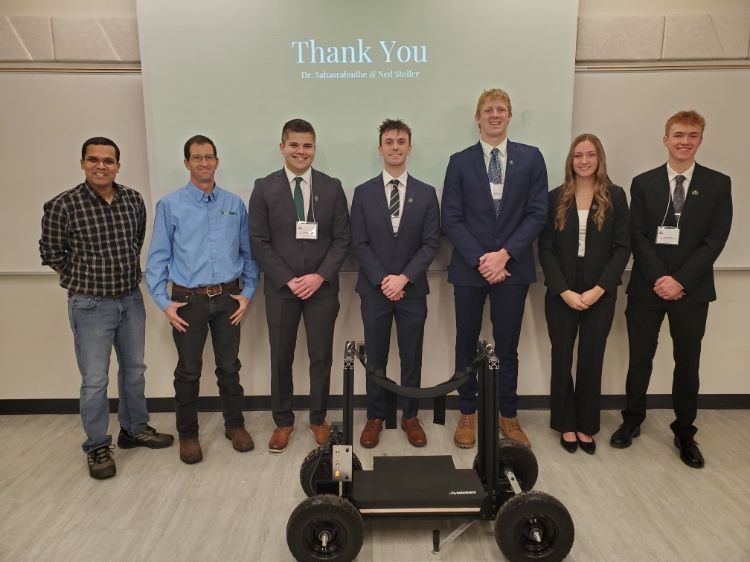 students standing behind a wheeled cart