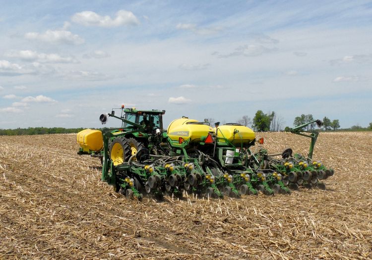 A tractor planting crops in a field