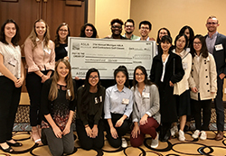 Students receive a Michigan American Society of Landscape Architects scholarship check.