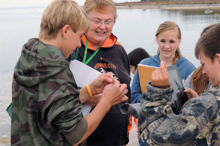 Rogers City Middle School THSP - teacher with students exploring samples image. Rogers City Middle School THSP - teacher with students exploring samples image.