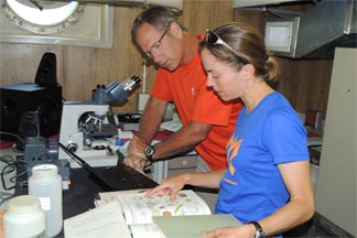 Teachers conduction research with microscope on R/V Lake Guardian. Teachers conduction research with microscope on R/V Lake Guardian.